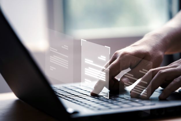 hand-using-laptop-computer-with-virtual-screen-and-document-for-online-approve-paperless-quality-assurance-and-erp-management-concept (1)