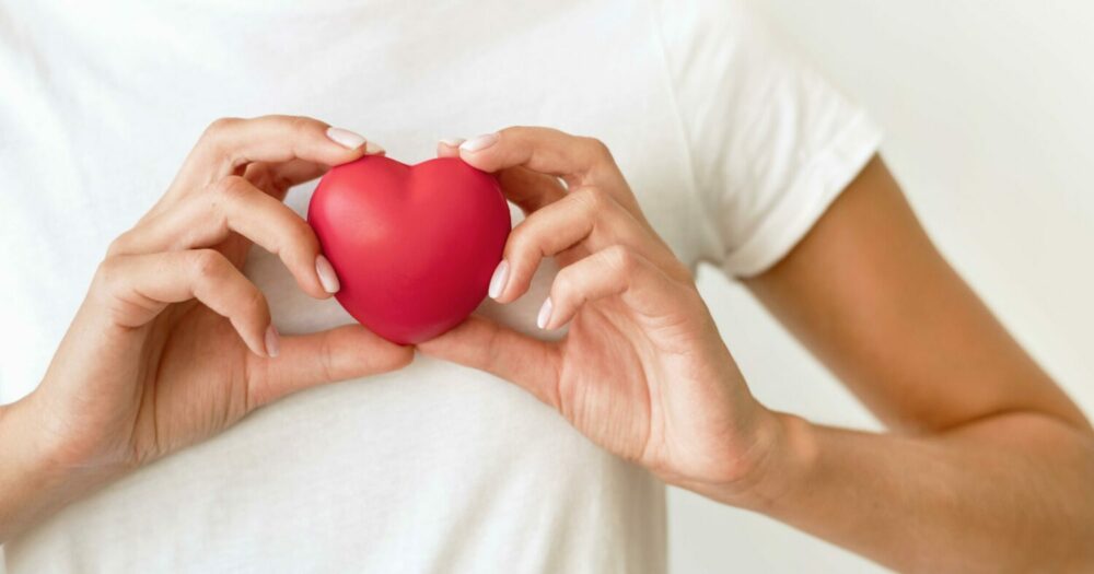 front-view-of-woman-holding-heart-shape-scaled-e1674033933252