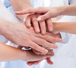 Medical team stacking hands